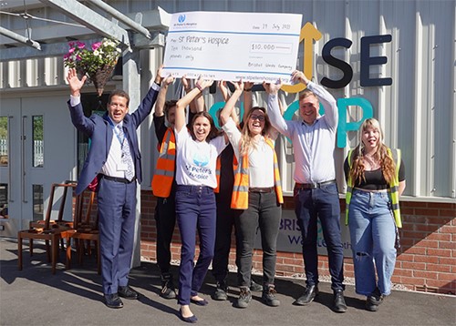 Staff from St Peter's Hospice and Bristol Waste with the giant cheque